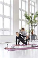 Woman practice yoga with teacher
