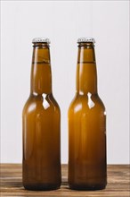 Close up two beer bottles wooden surface