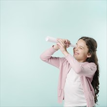 Girl with paper telescope
