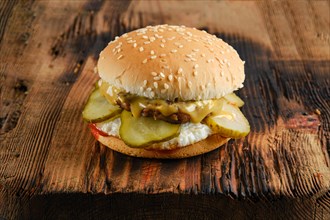 Burger with fried egg and pickled cucumber