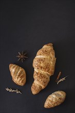 View croissants spices grains black background