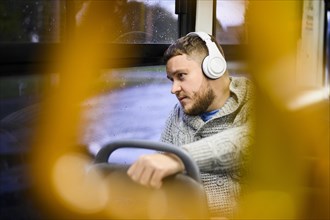 Man with headphones traveling by bus