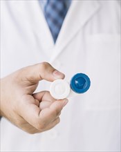 Doctor with holding pair contact lenses