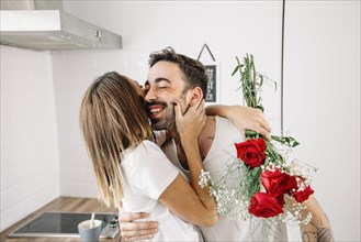 Woman hugging man after receiving bouquet