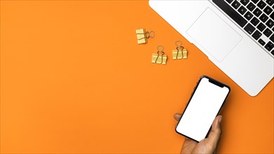 Top view mockup smartphone with orange background