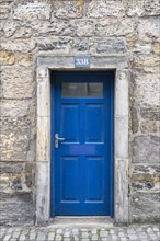 Blue front door on an old stone house