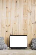 Close up laptop pillow soft fur against wooden backdrop