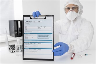Doctor holding covid test form