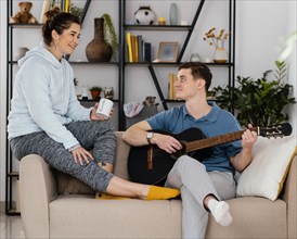 People with guitar couch