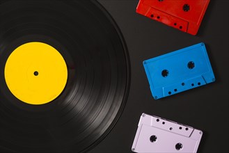 Three cassette tapes vinyl record black background