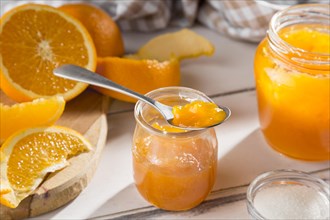 High angle clear glass jar with orange jam