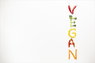 Vegan lettering made out vegetables with copy space