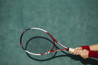 Woman holding tennis racket both hands