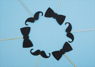 Bow ties mustaches wands form circle