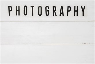 Elevated view graphy text white wooden table