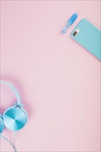 Elevated view headphone smartphone pink background