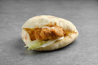 Flat bread with chicken fillet in breading