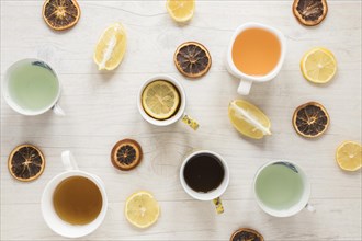 Various types tea ceramic cup dry grapefruit slices with lemon wooden background