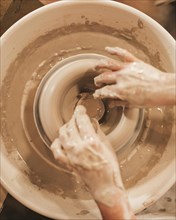 Hands woman process making clay bowl pottery wheel