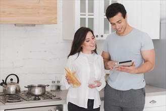 Couple learning how cook from online courses
