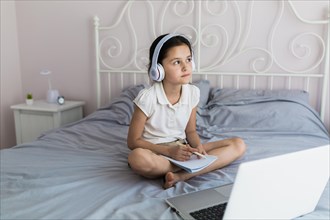 Lovely little girl using her laptop