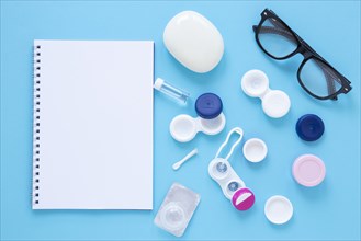 Eye care products blue background with notebook mock up
