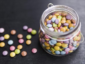 Multicolored glazed candies glass jar