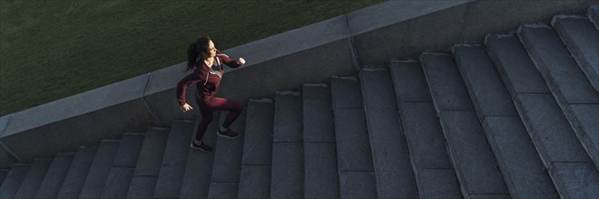 Fit young woman climbing stairs