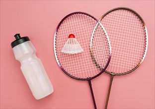 Flat lay badminton set with water bottle