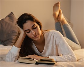 Woman reading book home bed