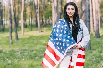 Young female covered with flag usa