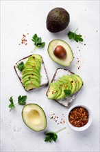 Flat lay avocado toast breakfast with herbs spices