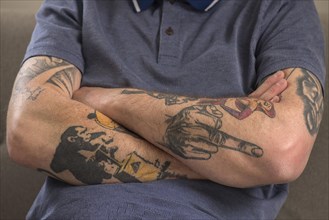 Crossed arms with tatoos