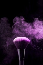 Makeup brush with neon fuchsia powder mist
