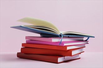 Arrangement with books pink background