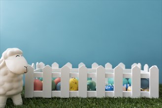 Easter background with sheep wooden fence