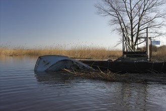 Capsized boat at the jetty of the Lower Weser island Strohauser Plate after a storm surge