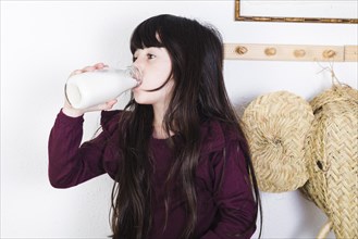 Girl drinking milk from bottle