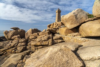 The rocks of the pink granite coast Cote de Granit Rose and the lighthouse Phare de Ploumanac'h near Ploumanac'h