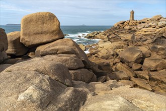 The rocks of the pink granite coast Cote de Granit Rose and the lighthouse Phare de Ploumanac'h near Ploumanac'h