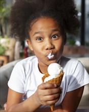 Medium shot girl eating ice cream