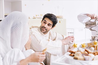 Eid concept with group friends eating