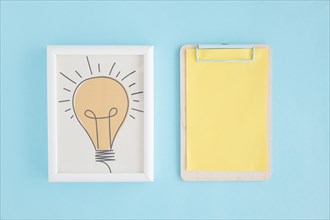 Hand drawn light bulb frame clipboard with yellow paper