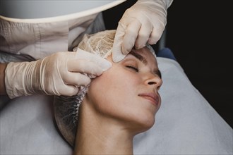 Young woman getting beauty procedure wellness center