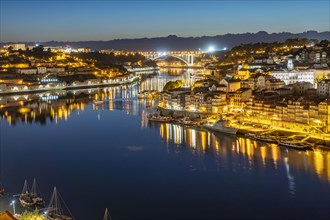 View over the river Douro to the old town of Porto and Vila Nova de Gaia at dusk