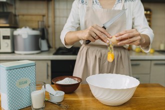 Woman breaks egg making pie kitchen