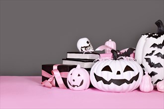 Pink and white Halloween decor with black and white pumpkins