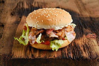 Beef chef hamburger with bacon on wooden background