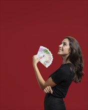 Woman showing her shopping money with copy space