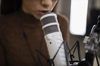 Woman with microphone doing radio show